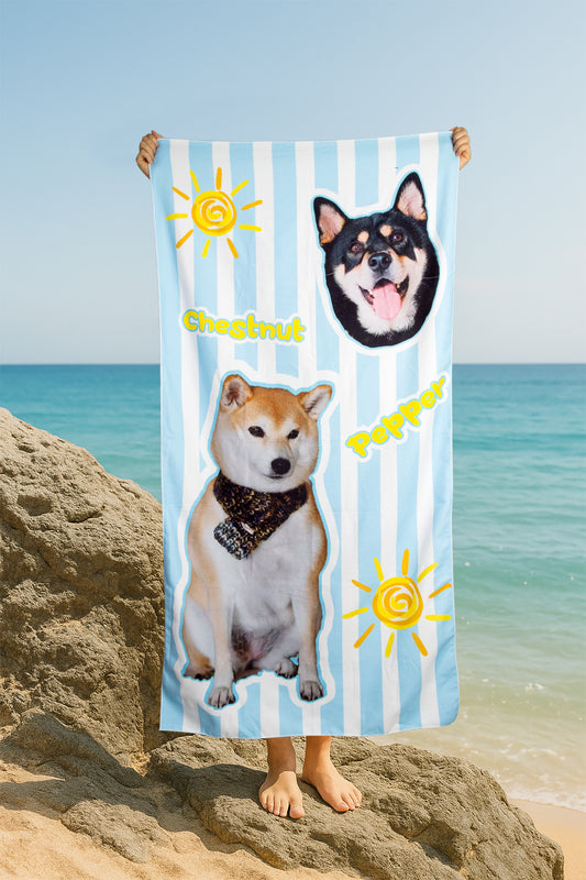 Towel with dog illustrations and text held up on a beach