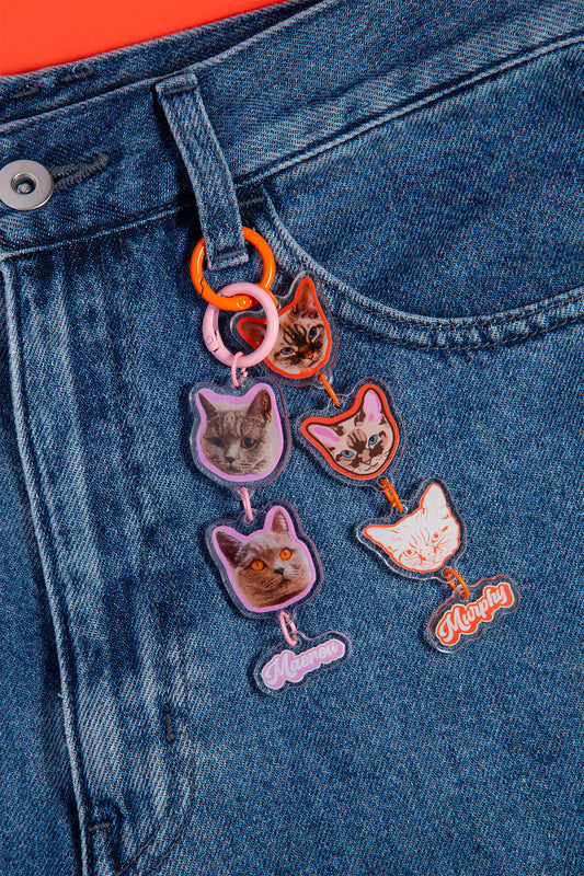 Cat-themed patches on a denim jacket