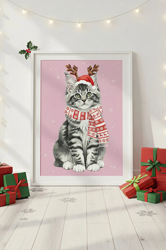 Framed artwork of a cat wearing a Santa hat and Christmas sweater on a pink background, surrounded by Christmas presents.
