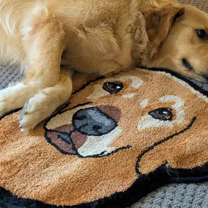 Dog lying on a dog-shaped rug with a face design.