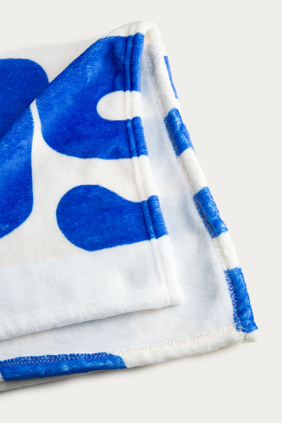 Folded towel with blue abstract pattern on a white background