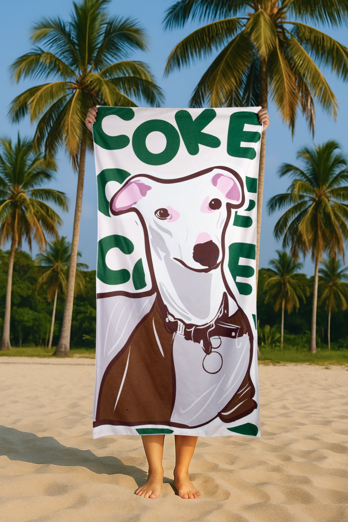 Towel with a dog design held by a person on a beach with palm trees in the background