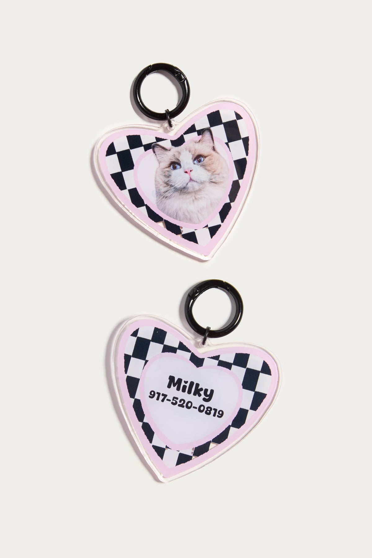 Heart-shaped pet tags with a checkered border and photo of a cat on a white background