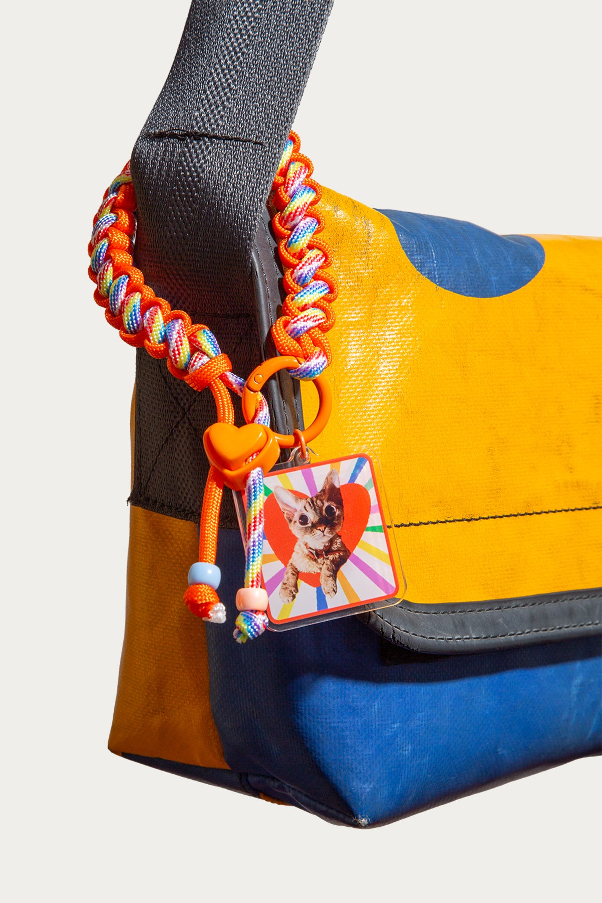 Colorful handbag with a dog tag featuring a small dog illustration on a plain background
