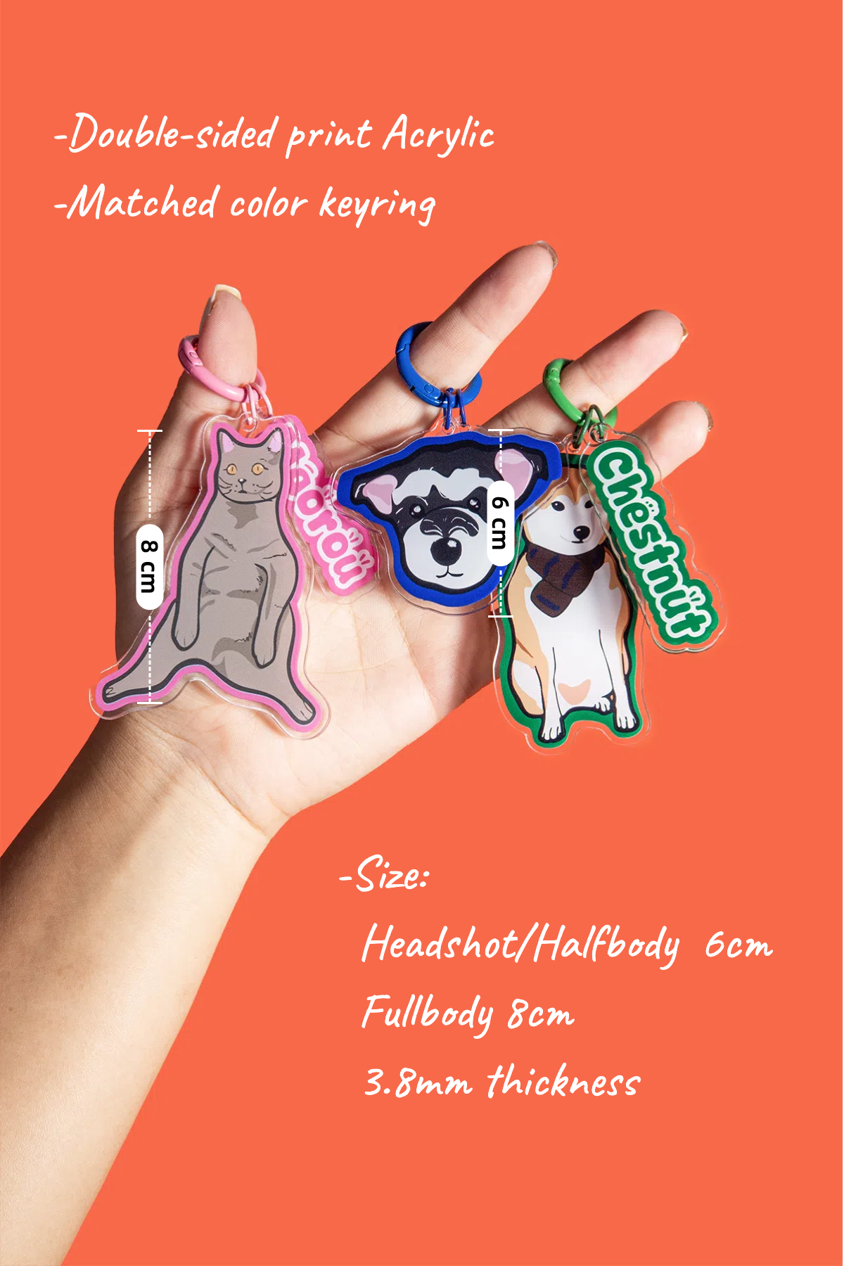 Hand holding three keychains with measurements and product details on an orange background