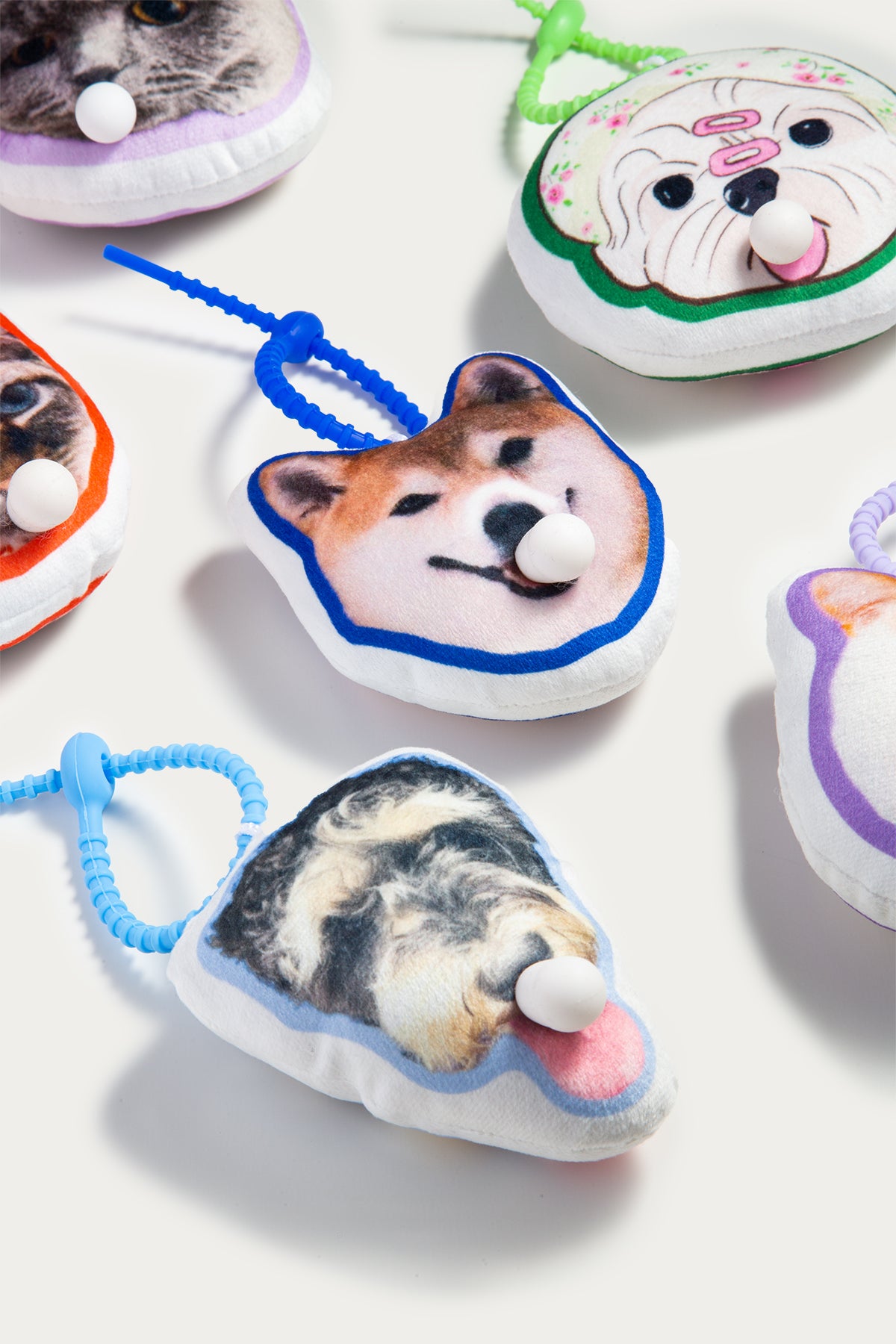 Pet toys with dog faces on a white background