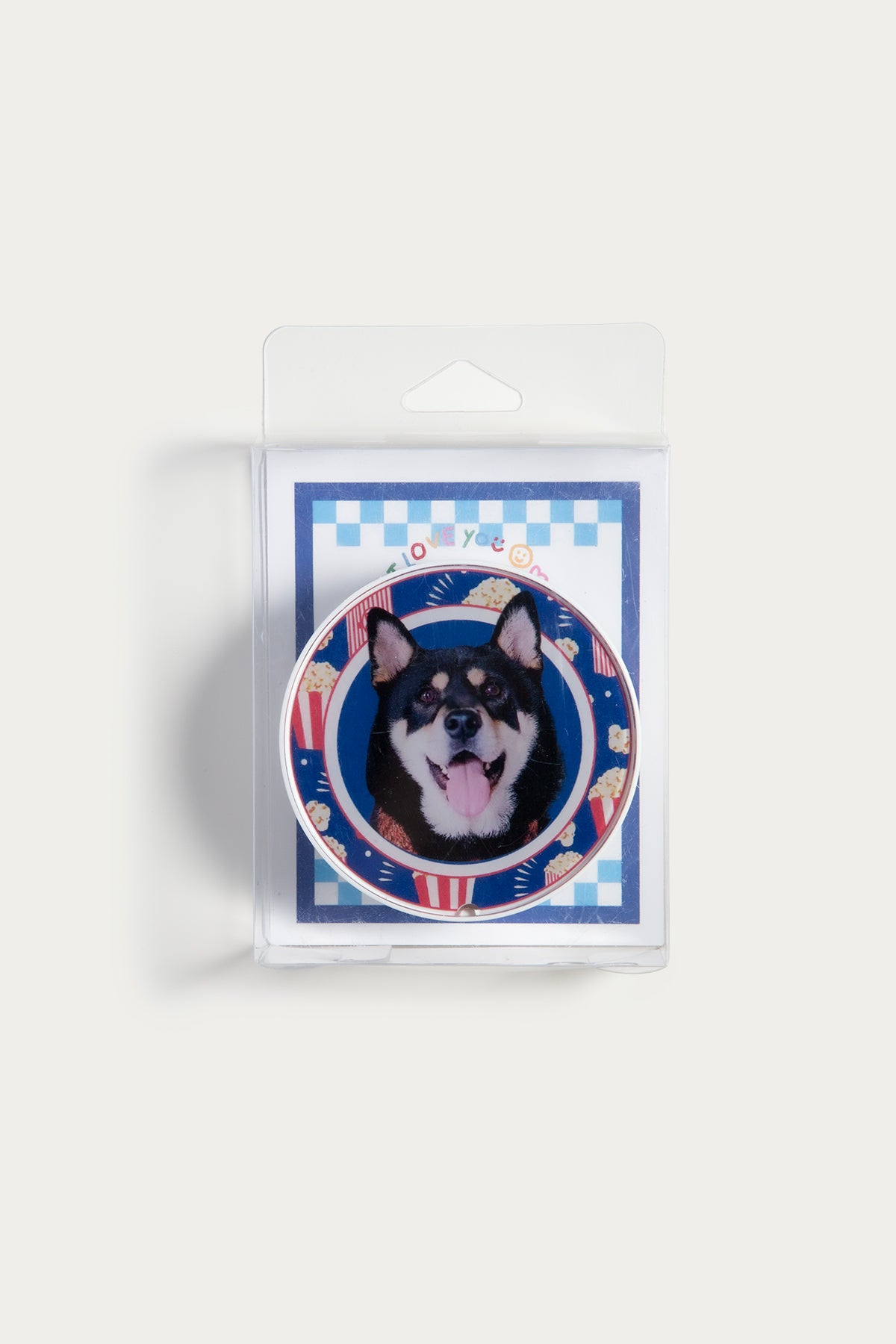 Dog magnet in packaging with a checkered border on a white background