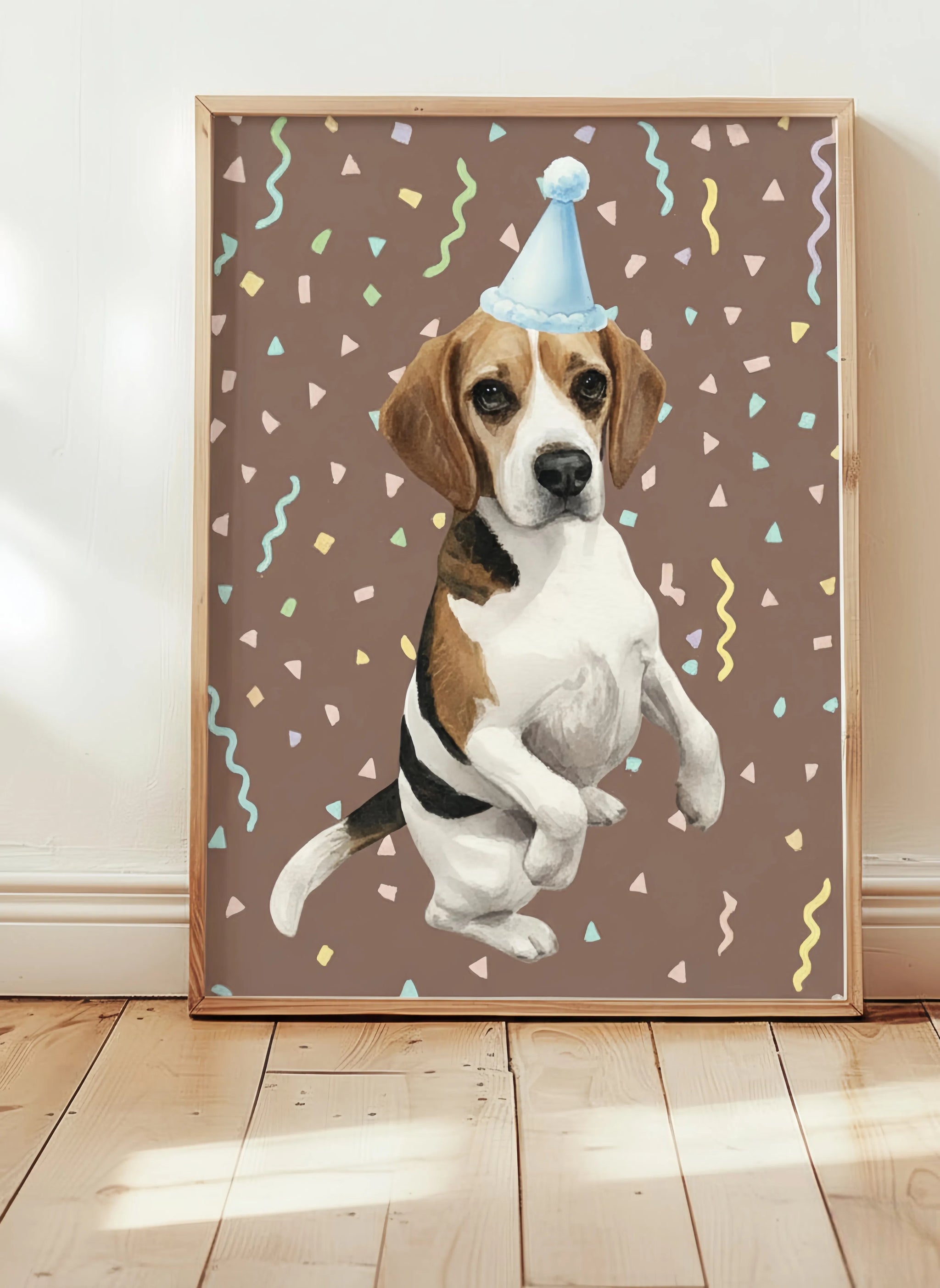 Framed artwork of a dog wearing a party hat on a brown background with colorful confetti.