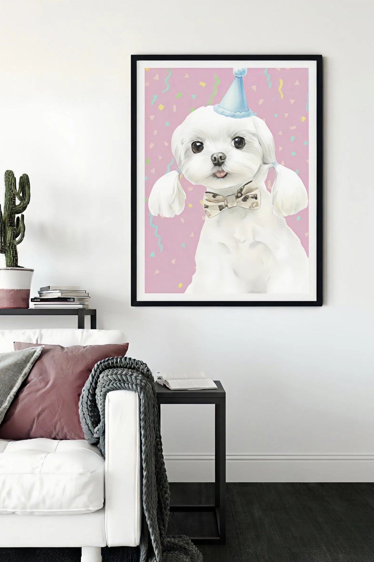 Framed artwork of a white dog wearing a party hat on a pink background, displayed in a living room.