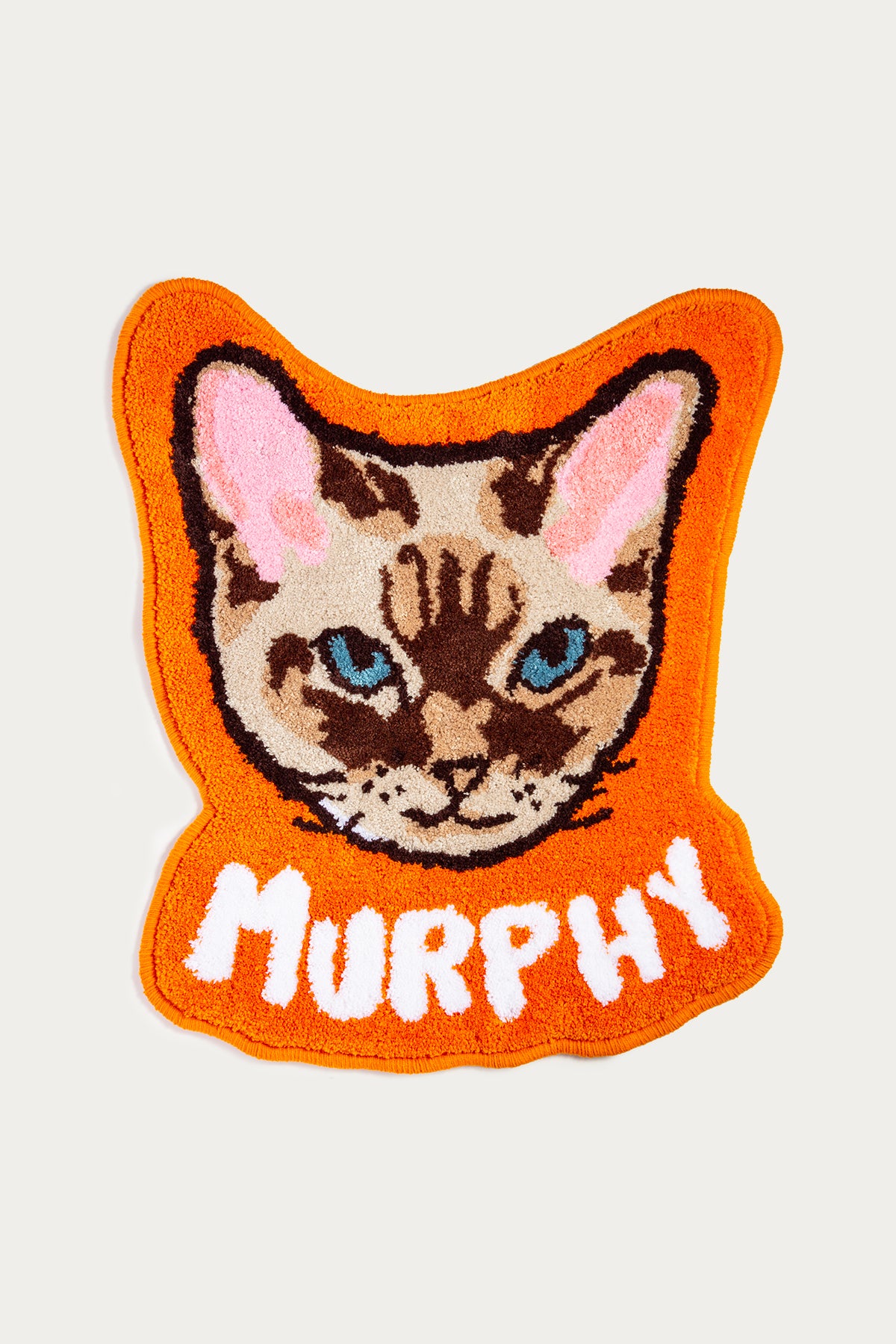 Embroidered patch of a cat's face with 'Murphy' on an orange background