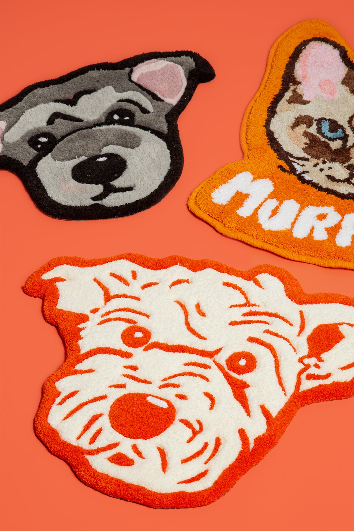Three dog-themed patches on an orange background